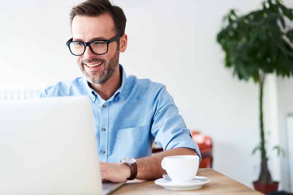 Handsome man at cafeteria, cafe working on laptop image